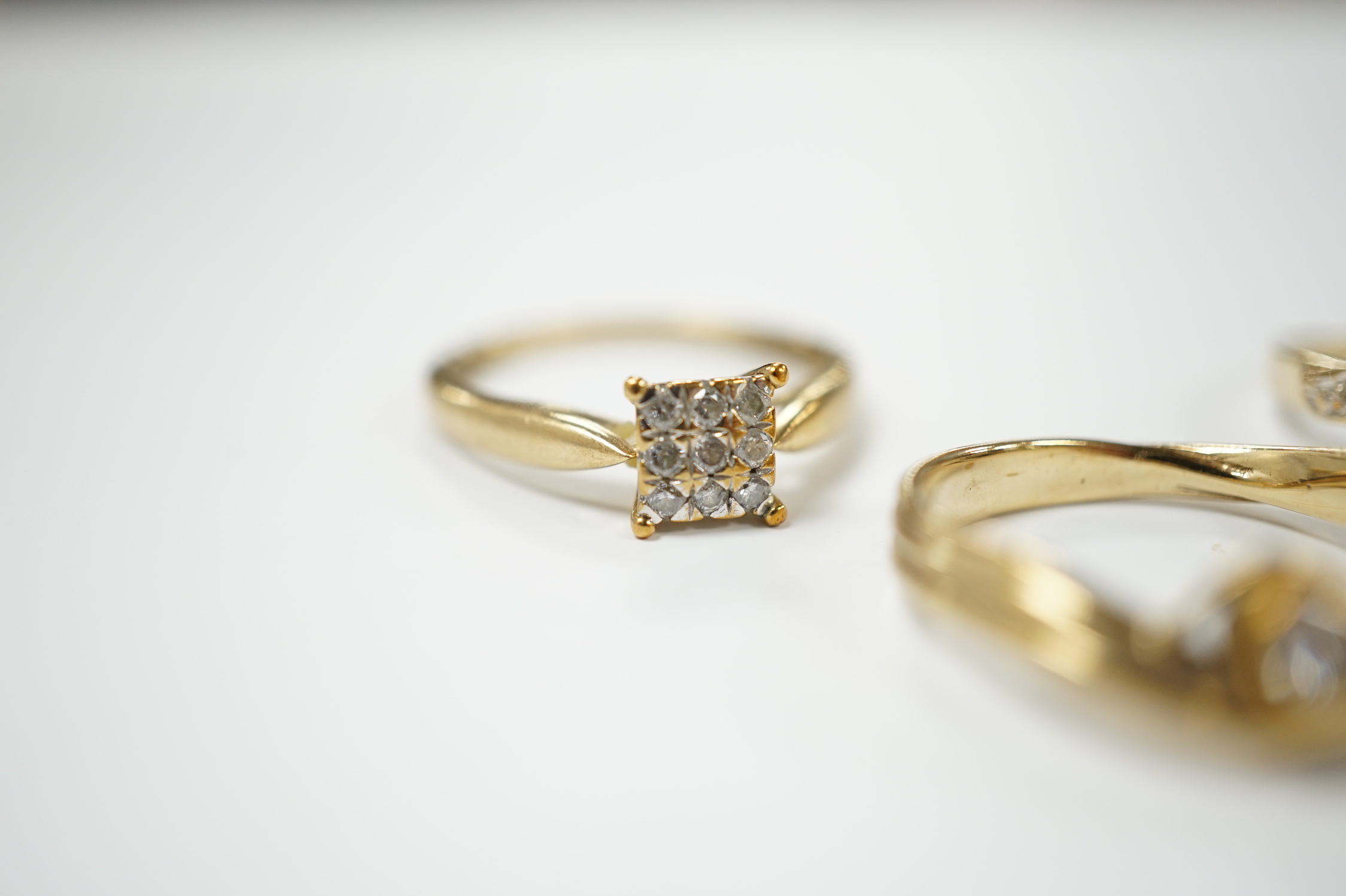 Three modern 9ct gold and diamond set rings, including solitaire and cluster, gross weight 5.9 grams.